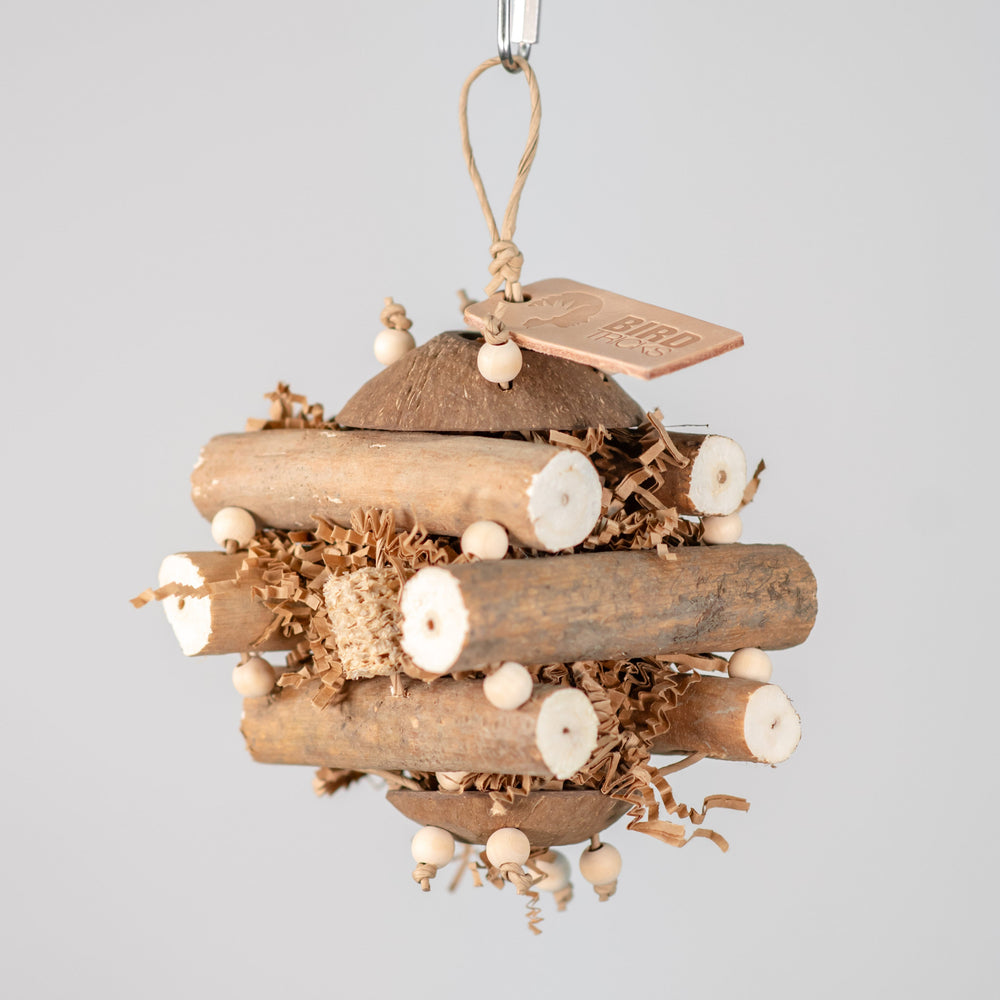 Sola Cabin small bird toy with sola logs, coconut shell, corn cob, and crinkle paper for foraging parrots